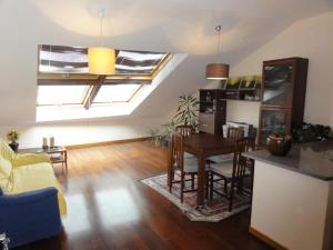 a living room with a table and a dining room at Apartamento Playa Langosteira in Fisterra