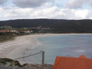 a view of a beach and the ocean at Apartamento Playa Langosteira in Fisterra +5 photos