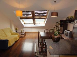 a living room with a couch and a table at Apartamento Playa Langosteira in Fisterra