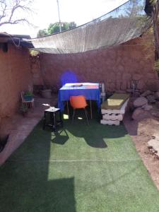 a patio with a table and chairs under a tent at Guest House Diaguitas in San Pedro de Atacama