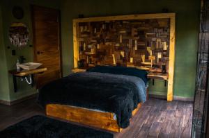 a bedroom with a large bed with a wooden headboard at Modern and cozy cabana in La Cofradía