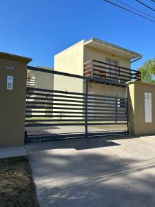 a house with a gate in front of a building at Villa Los Cóndores in Las Chacras