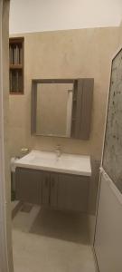 a bathroom with a sink and a mirror at Villa KN in Ambalangoda