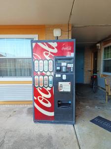 a cocacola machine sitting outside of a building at American Inn & Suites By Capital O Victoria US-59 in Victoria