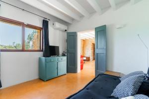 a living room with a couch and a tv at Trullo dei Beneficati By Vivimy in Taviano
