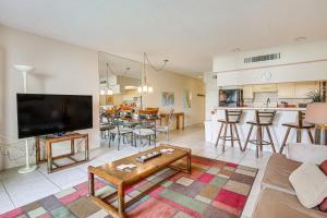 a living room with a couch a table and a kitchen at 3 Mi to Dtwn Palm Springs Condo with Pool Access! in Palm Springs