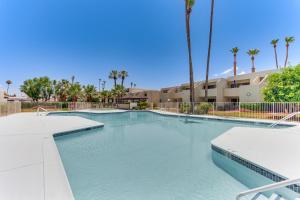 a swimming pool at a resort with palm trees at 3 Mi to Dtwn Palm Springs Condo with Pool Access! in Palm Springs