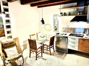 a kitchen with a table and chairs and a stove at Indipendent house in Venice in Venice