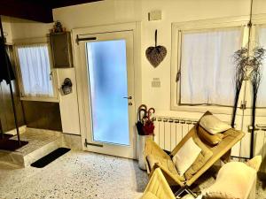 a living room with a chair and a door at Indipendent house in Venice in Venice +24 photos