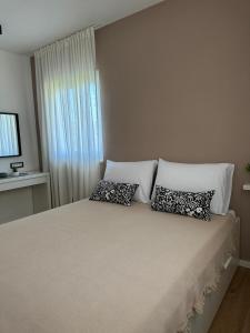 Postel nebo postele na pokoji v ubytování Apartmani Palada
