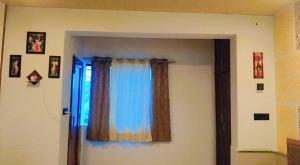 a room with a door with a window with curtains at Unnati Guest House in Vrindāvan