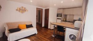 a small living room with a couch and a kitchen at Colibri in Val-des-Prés +18 photos