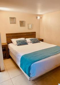 a bedroom with a large bed with blue and white sheets at Loft Frente a la Playa!!!! in Boca del Río