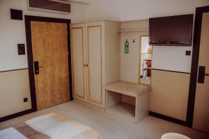 a small room with a door and a television at Dworek in Kolbuszowa +78 photos