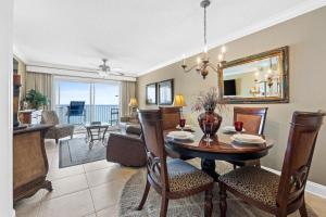 a dining room and living room with a table and chairs at Summerlin 502 in Fort Walton Beach