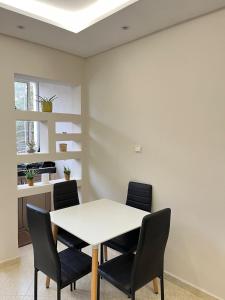 a dining room with a white table and chairs at Centre D'estivage Imi Ouaddar in Agadir nʼ Aït Sa