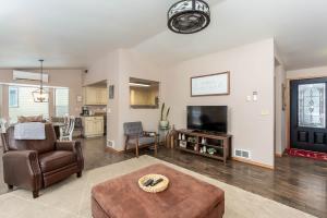 a living room with a couch and a tv at River Run Getaway Private Dock Pet Friendly Kayaks in Bend