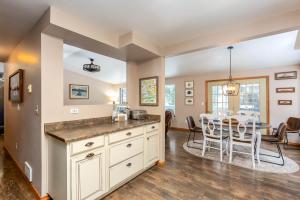 a kitchen and dining room with a table and chairs at River Run Getaway Private Dock Pet Friendly Kayaks in Bend +36 photos