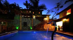 a swimming pool in front of a house at night at Buzios Casa #6 in Búzios +6 photos