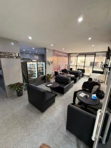 a lobby with couches and tables in a building at Prestige Dakar in Ouakam