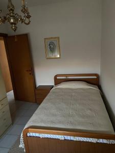 a bedroom with a bed in a room at Appartamento Hellas in Marotta +1 photo