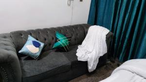 un sofá con almohadas en la sala de estar en Flo Steve Stays, en Nairobi