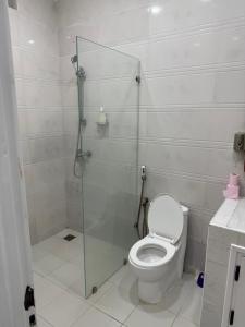 a bathroom with a toilet and a glass shower stall at Prestige Dakar in Ouakam +38 photos