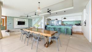eine Küche und ein Esszimmer mit einem Holztisch und Stühlen in der Unterkunft Lime Samui 10: Perfect for Families and Events in Koh Samui 