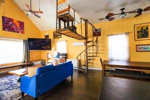 a living room with a blue couch and a piano at Denver Oasis 5BR Home with Hot Tub, Sleeps 16 in Denver