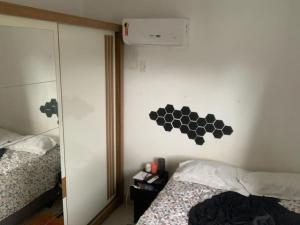 a bedroom with two beds and a mirror at Apto Br 316 , a 10 min do parque da Cop30 in Ananindeua +5 photos