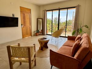 a living room with a couch and a table at Casa Zianda - Departamentos en Puerto Escondido in Brisas de Zicatela