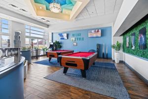 a billiard room with two pool tables in a room at Serene Oceanfront Getaway 1BR with Private Balcony at Wyndham Oceanwalk in Daytona Beach