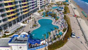 an aerial view of a pool at a resort at Serene Oceanfront Getaway 1BR with Private Balcony at Wyndham Oceanwalk in Daytona Beach