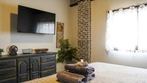 a bedroom with a bed with a tv on the wall at Rivers Edge Lofts - Unit 8 in Niles
