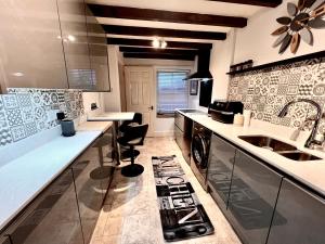 a kitchen with a sink and a counter at Sunny Hill Cottage Milford with fabulous views near Belper Duffield in Belper
