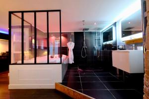 a bathroom with a shower and a robe in a room at Rouen centre - Welcome to Romain in Rouen +39 photos