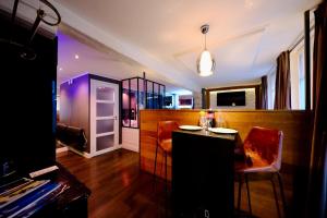 a dining room with a table and two chairs and a room at Rouen centre - Welcome to Romain in Rouen