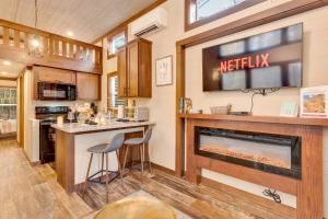 a kitchen with a fireplace and a television on a wall at Dreamer at Mentone with Free Internet in Mentone