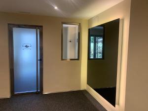 a hallway with two mirrors and a glass door at Maribel Arttyco a pie de pista con Parking cubierto in Sierra Nevada