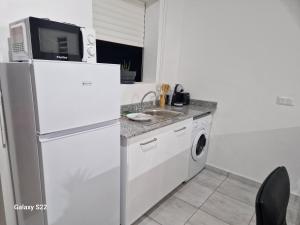 Kuchyň nebo kuchyňský kout v ubytování Villa COEUR KERA