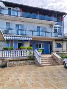 a large white building with a balcony at Apartments Kety in Jezera
