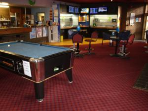 a pool table in a room with chairs at Seabrook Hotel in Somerset