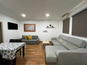 a living room with a couch and a table at Hello Home Canillas in Madrid