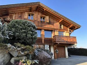 a large wooden house with windows on the side of it at Chalet Medonnet - CHALET 10 personnes Combloux MAE-7241 in Combloux