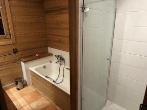 a bathroom with a bath tub and a shower at Chalet Medonnet - CHALET 10 personnes Combloux MAE-7241 in Combloux +8 photos