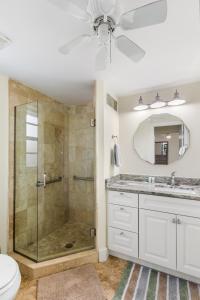 a bathroom with a shower and a toilet and a sink at Waterfront! Canal View, dock Heated Pool - The Fair View of the Bay - Roelens in Fort Myers Beach