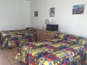 Postel nebo postele na pokoji v ubytování Sunshine Motel