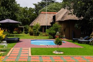 a house with a yard with a swimming pool at Manna House in Vereeniging