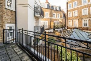 a balcony with a black railing and some buildings at -Air con- Luxury Townhouse - High St Kensington! in London