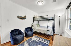 a bedroom with a bunk bed and a rug at The Honey Hole St George Island Pet Friendly-Heated Private pool West Gulf beaches in St. George Island +17 photos